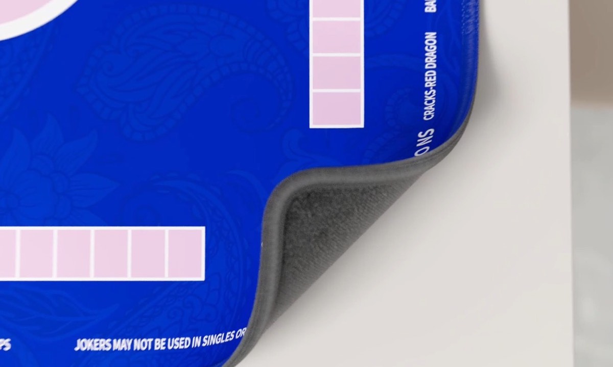 Mat corner showing the printed reminder that Jokers may not be used in singles or pairs