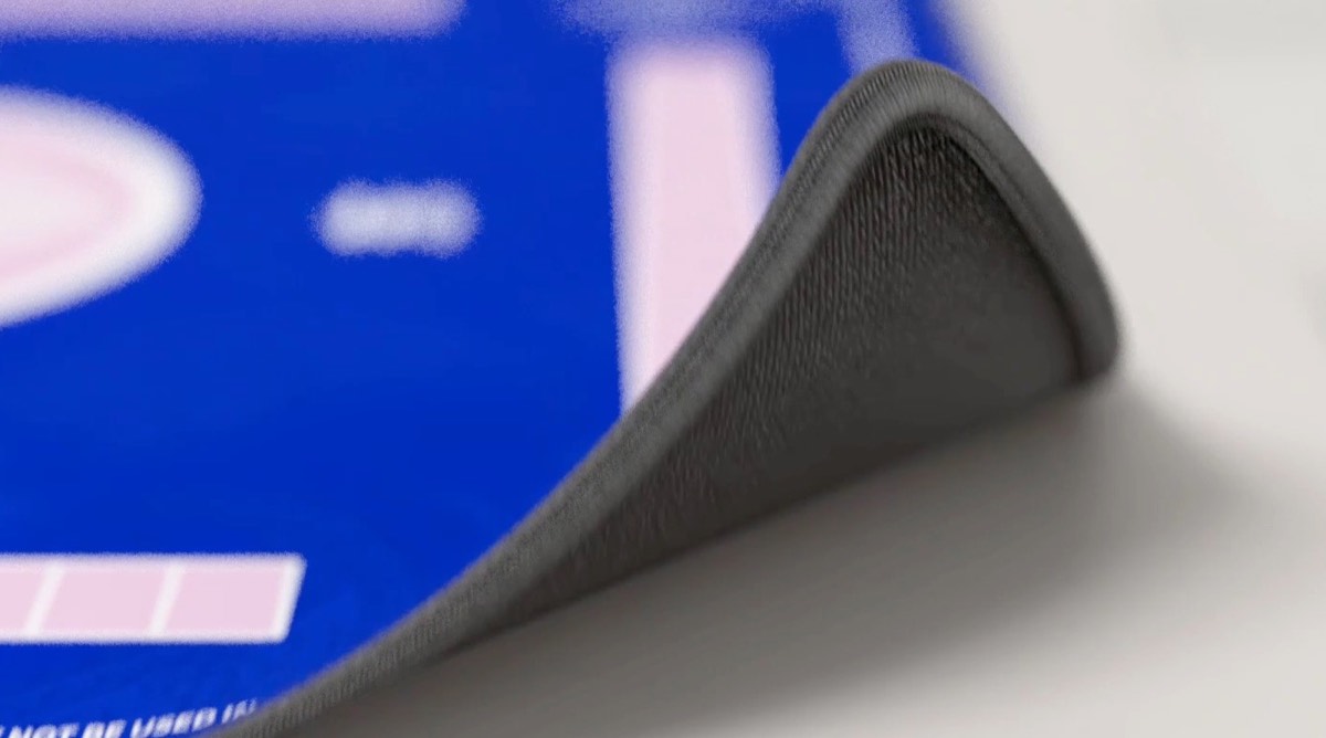 Corner of the mat turned up to show the gray non-slip rubber base
