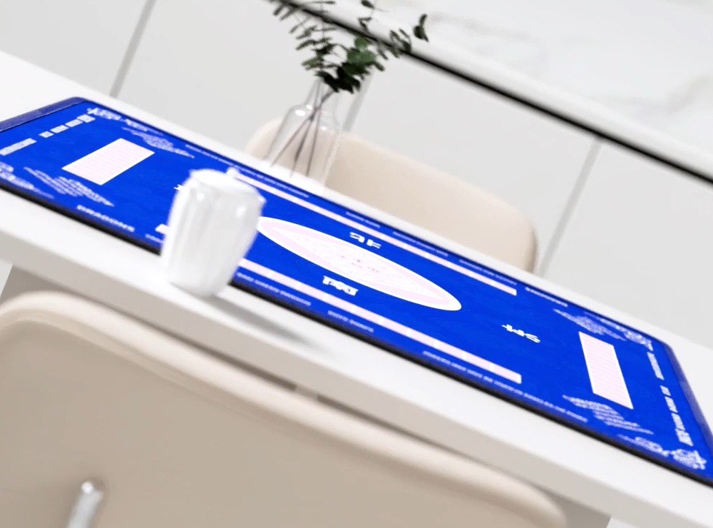 Blue 2F22E mahjong mat laid on a white dining table
